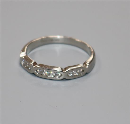 A modern 18ct white gold and seven stone diamond half hoop ring, size N/O.